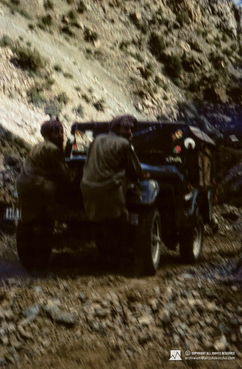 Porters riding on jeeps.