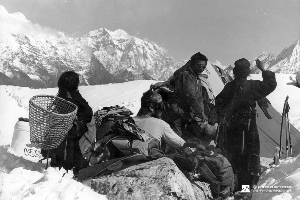 Nepali porters and Artur Hajzer (sitting) at the base.