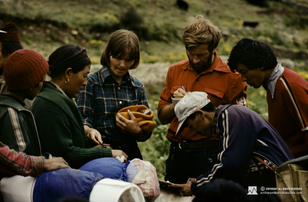 Participants of the expedition while settling accounts with the porters. In the center from the left: Małgorzata Kiełkowska (in a checked shirt) and Leszek Czarnecki (in a red shirt).