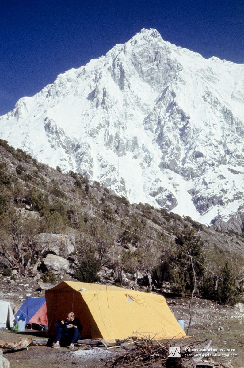 Tadeusz Piotrowski in the base. In the background, the south-east pillar of Nanga Parbat is visible.