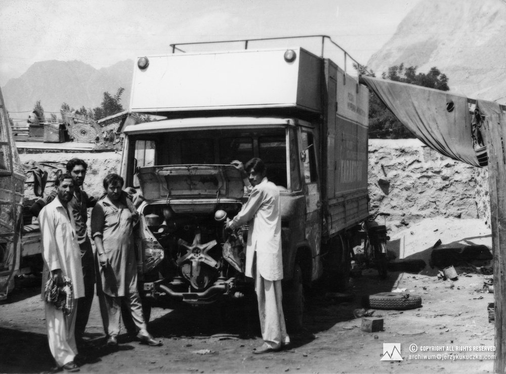 Expedition truck being repaired by Pakistani mechanics.