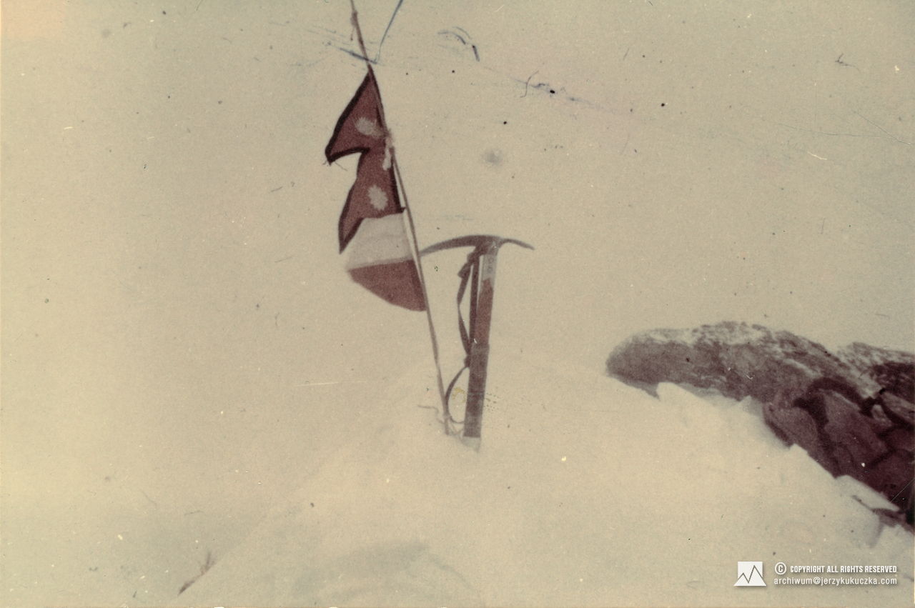 Flags of Poland and Nepal and an ice ax on the top of Dhaulagiri - 01/21/1985 (8167 m above sea level).