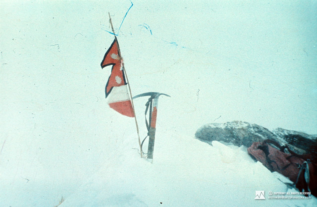 Flags of Poland and Nepal and an ice ax on the top of Dhaulagiri - 01/21/1985 (8167 m above sea level).