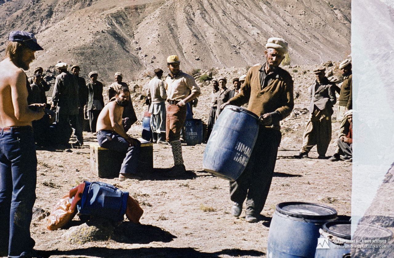 Participants of the expedition and porters at the base camp. From left without shirts: Jerzy Kukuczka and Janusz Majer. With a yellow cap: Shoaib Hameed.